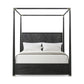 Black metal canopy bed with white bedding on a white background