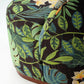 Tropical leaf patterned fabric with flowers on a white background