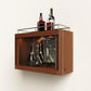 Wooden wall-mounted bar cabinet with bottles and glasses on a white background