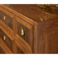 Close-up of a wooden dresser with gold handles