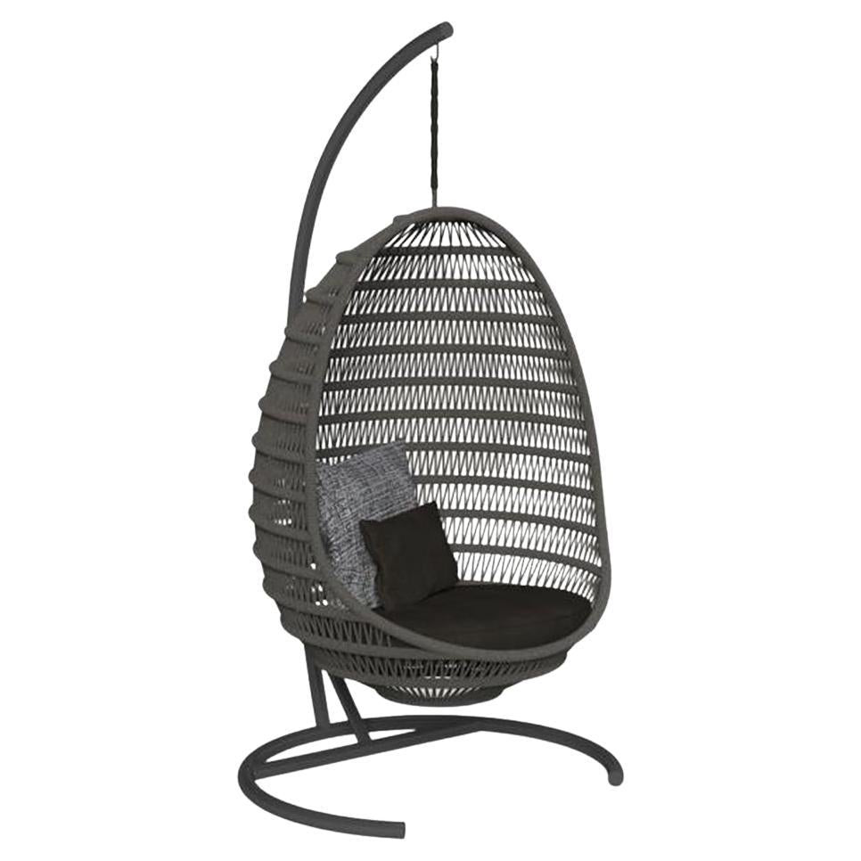 Black woven hanging chair with a stand on a white background