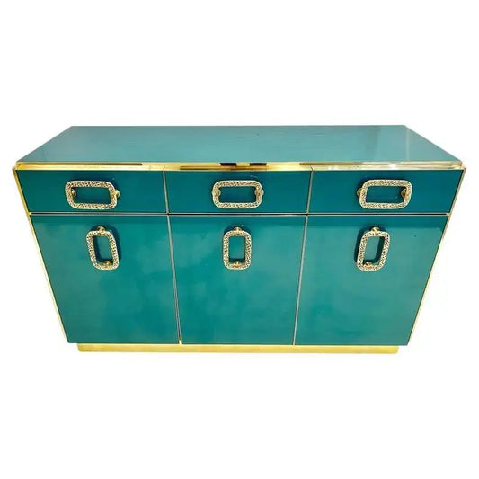 Teal console table with gold accents on a white background