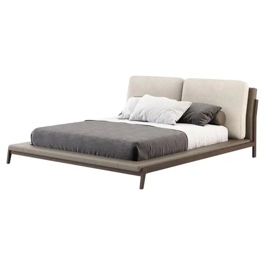 Modern bed with gray bedding and white pillows on a white background
