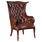 Brown leather armchair with tufted backrest on a white background