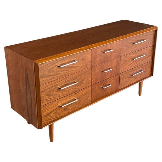 Wooden dresser with multiple drawers on a white background