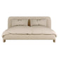 Beige upholstered bed with pillows on a white background