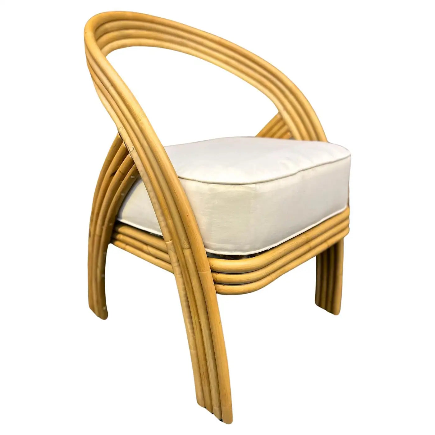 Wicker chair with a white cushion on a white background