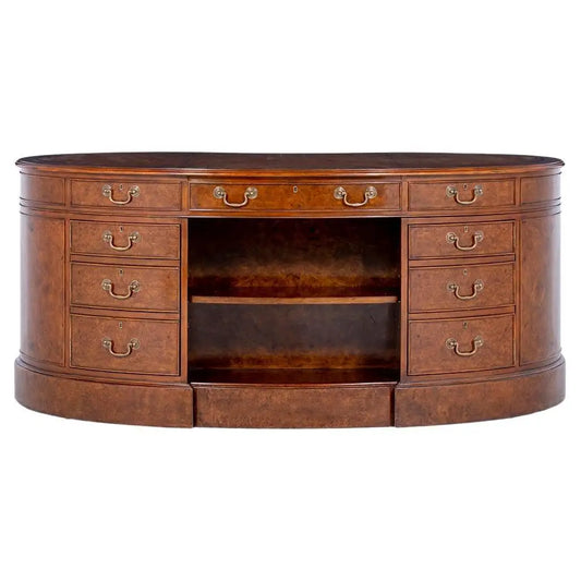 Wooden desk with multiple drawers and a central shelf on a white background