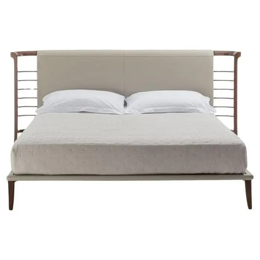Bed with metal frame and upholstered headboard on a white background