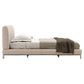 Beige upholstered bed with bedding on a white background