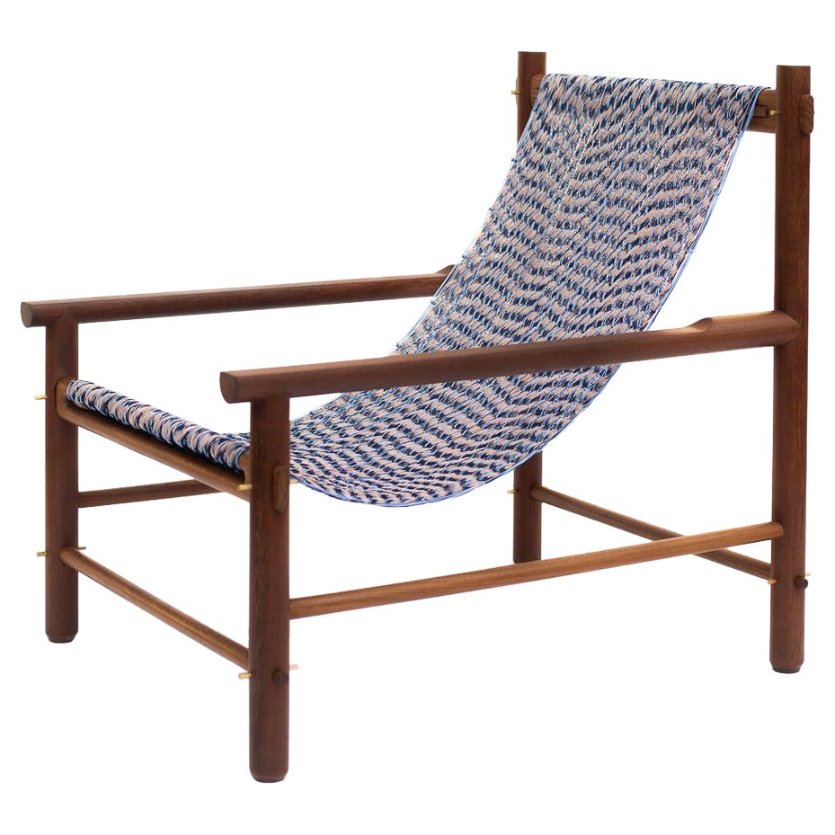 Wooden chair with a blue and white patterned seat on a white background