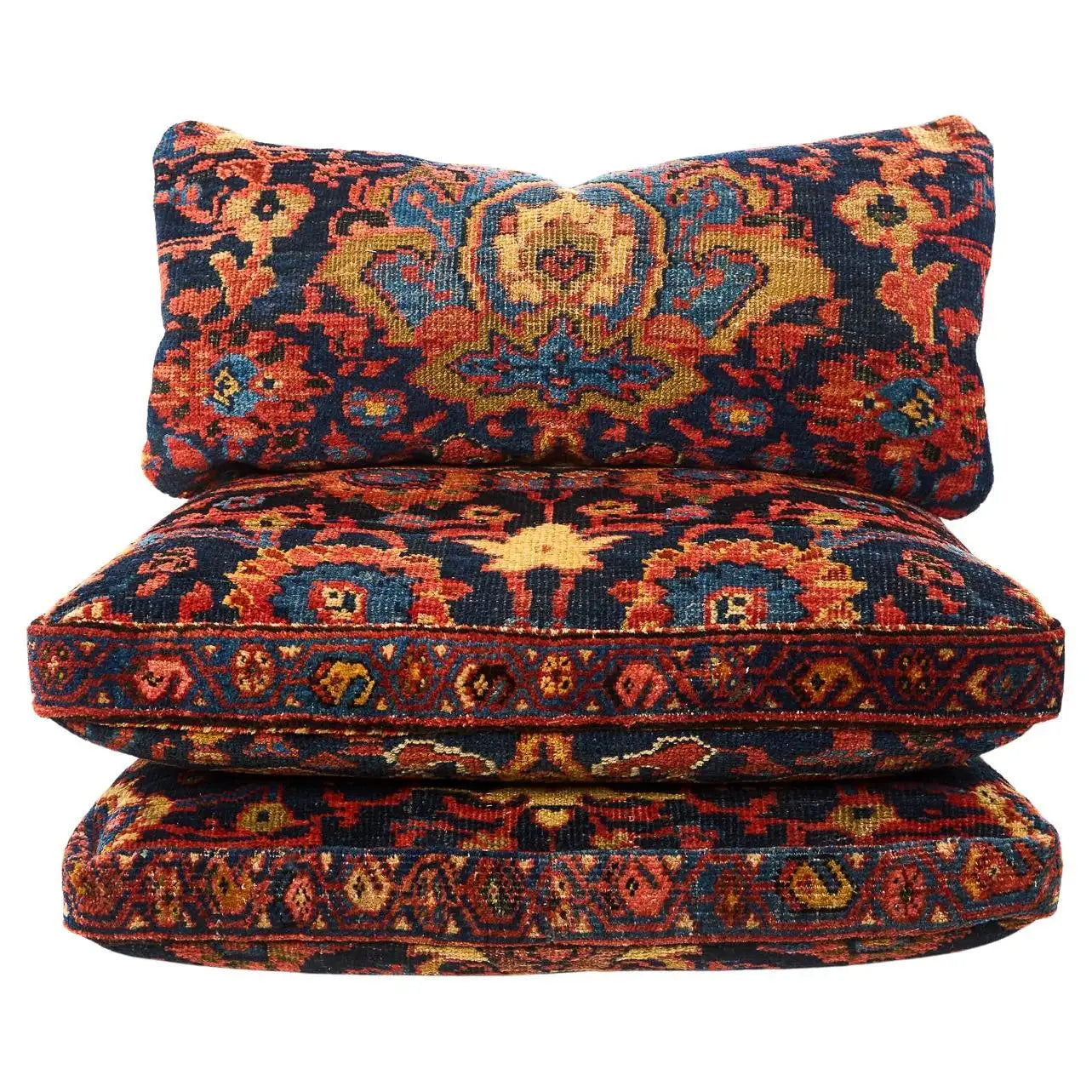 Three patterned cushions stacked on a white background