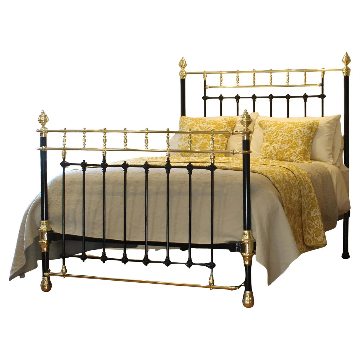 Decorative bed with gold and black metal frame and yellow bedding on a white background