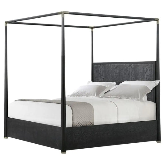 Black metal canopy bed with white bedding on a white background