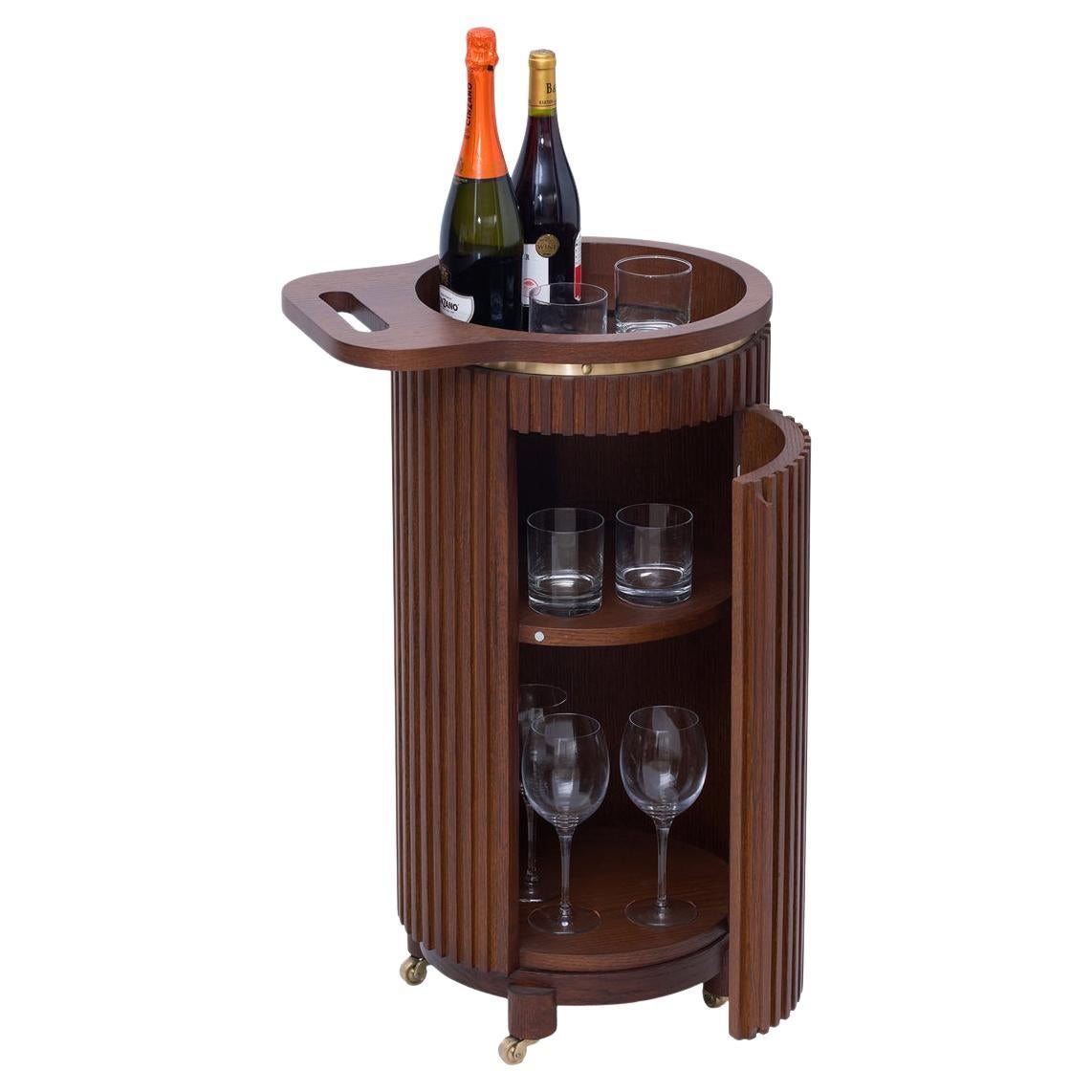 Wooden bar cart with bottles and glasses on a white background