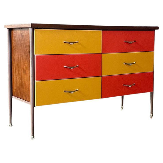 Colorful dresser with yellow and red drawers on a white background