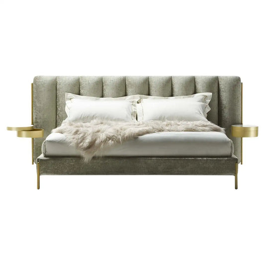 Gray upholstered bed with gold armrests and white bedding on a white background