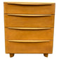 Wooden dresser with four drawers on a white background