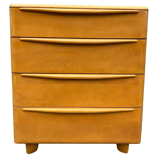 Wooden dresser with four drawers on a white background