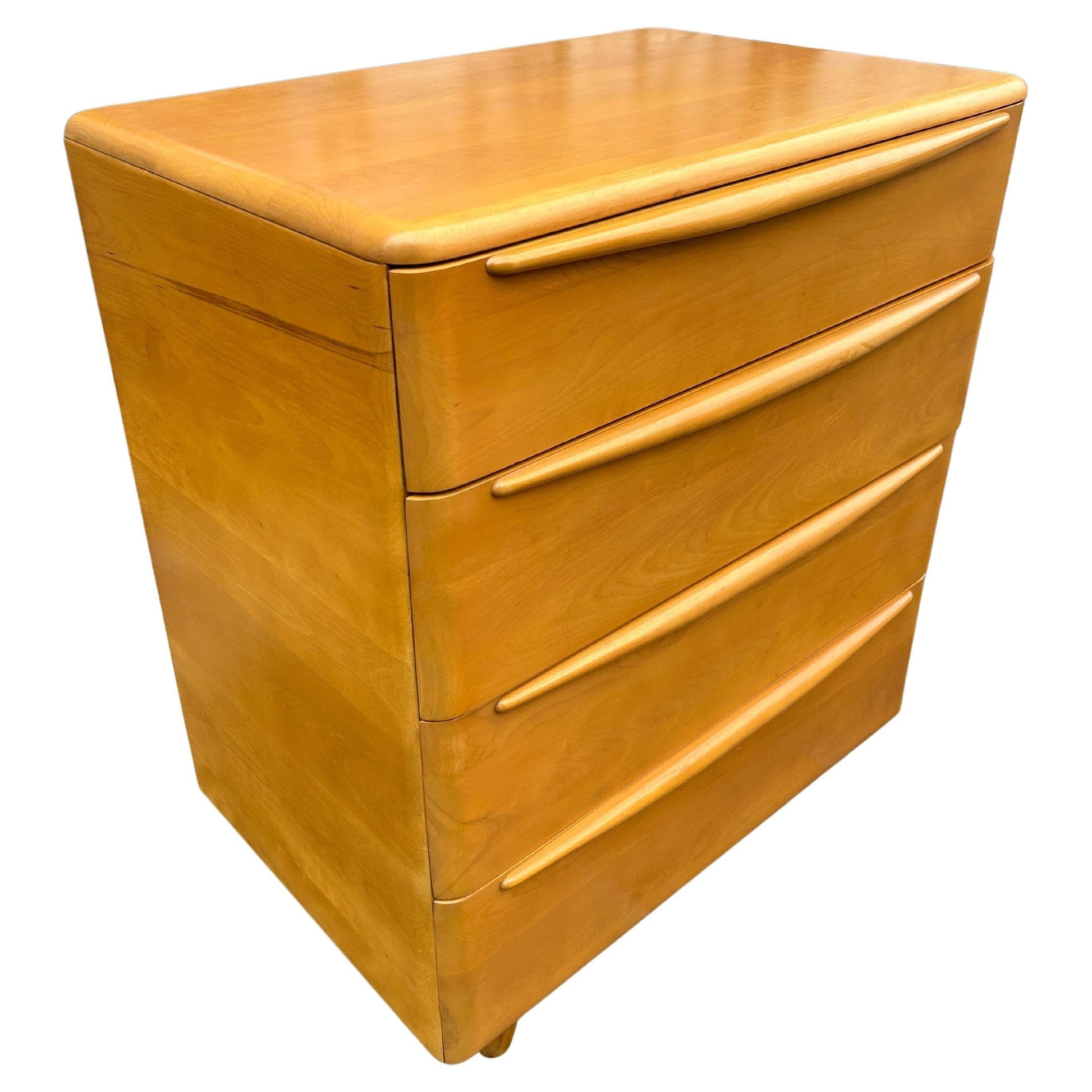 Wooden dresser with four drawers on a white background