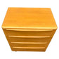 Wooden nightstand with three drawers on a white background