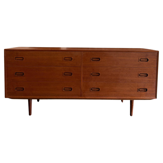 Wooden dresser with multiple drawers on a white background