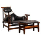 Vintage lounge chair with wooden frame and black leather cushions on a white background