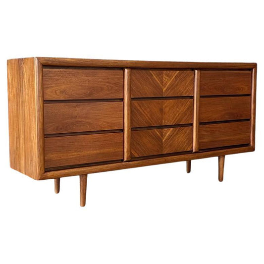 Wooden dresser with multiple drawers on a white background