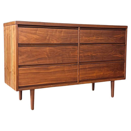 Wooden dresser with four drawers on a white background
