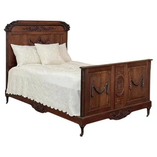 Vintage-style wooden bed with intricate carvings and white bedding on a white background