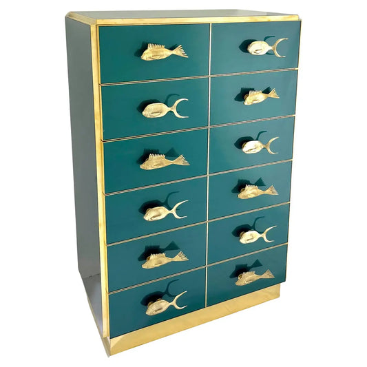 Teal dresser with gold fish-shaped handles on a white background