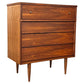 Wooden dresser with four drawers on a white background