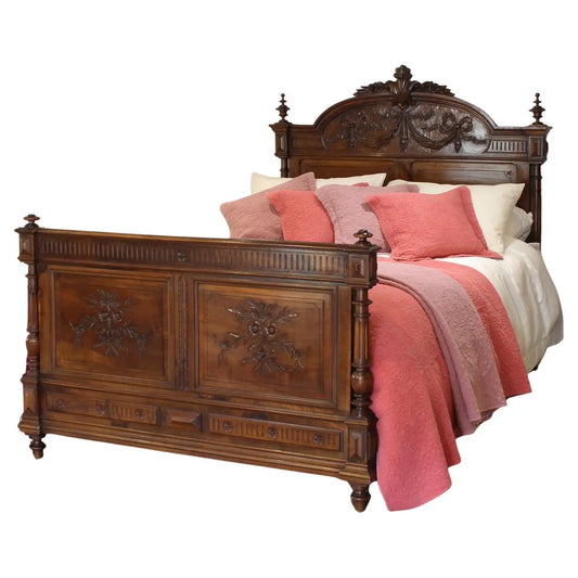 Wooden bed with intricate carvings and pink bedding on a white background