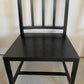 Black wooden chair against a plain background