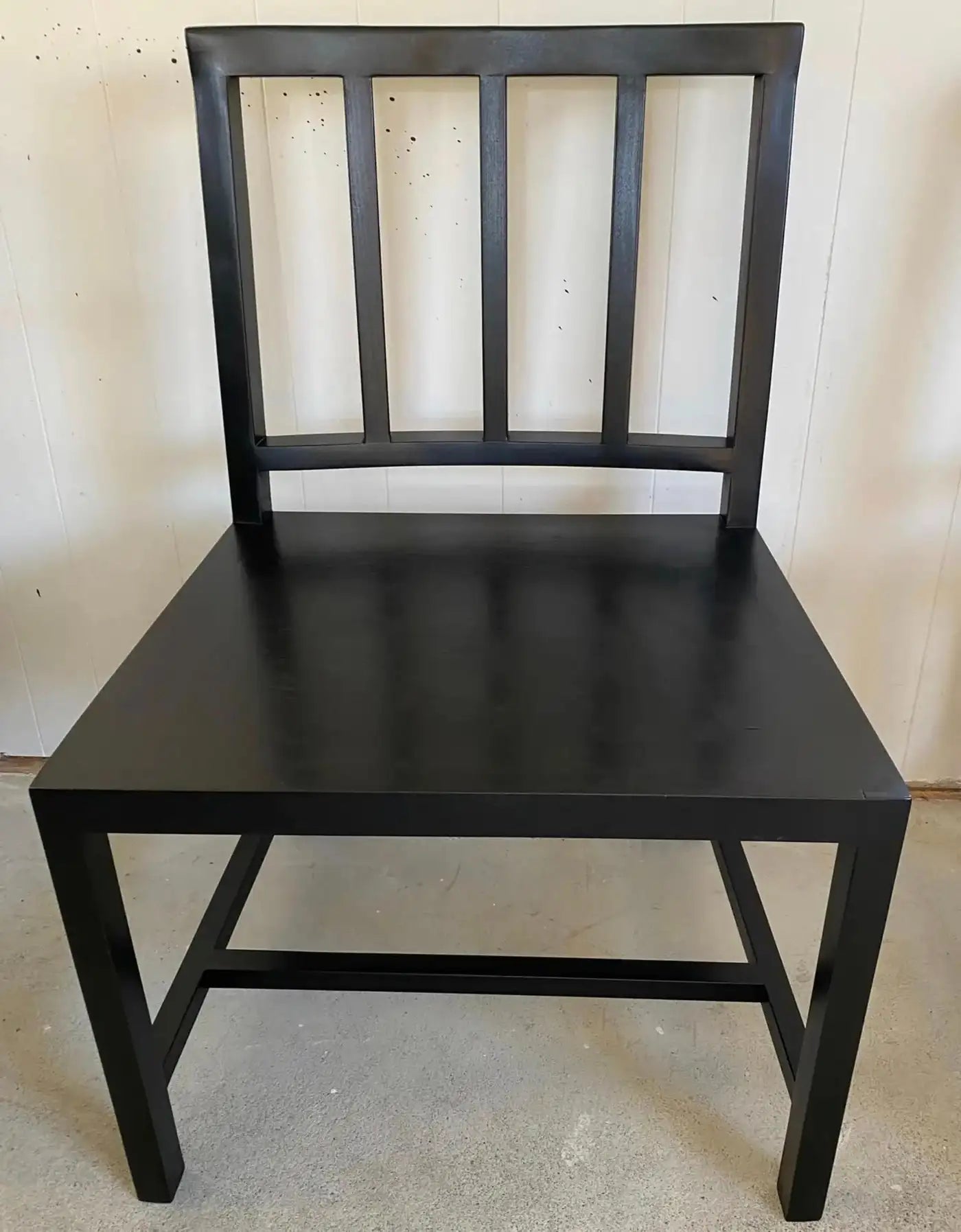 Black wooden chair against a plain background