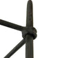 Close-up of a black metal rod with a knotted design on a white background