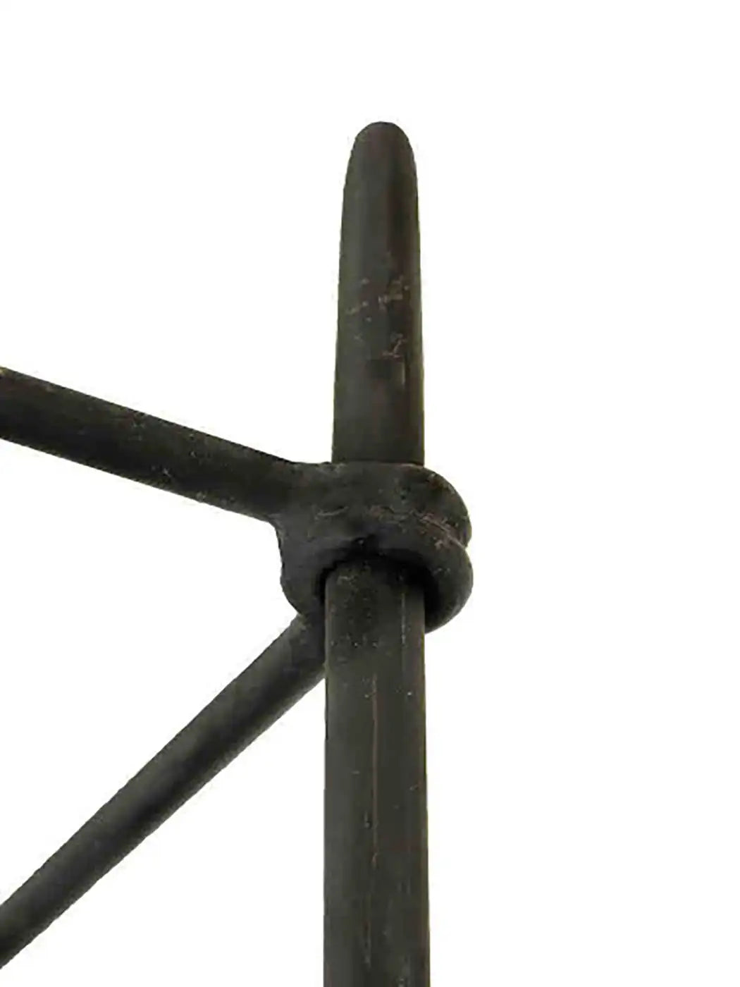 Close-up of a black metal rod with a knotted design on a white background