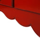 Close-up of a red decorative item with scalloped edge on a white background