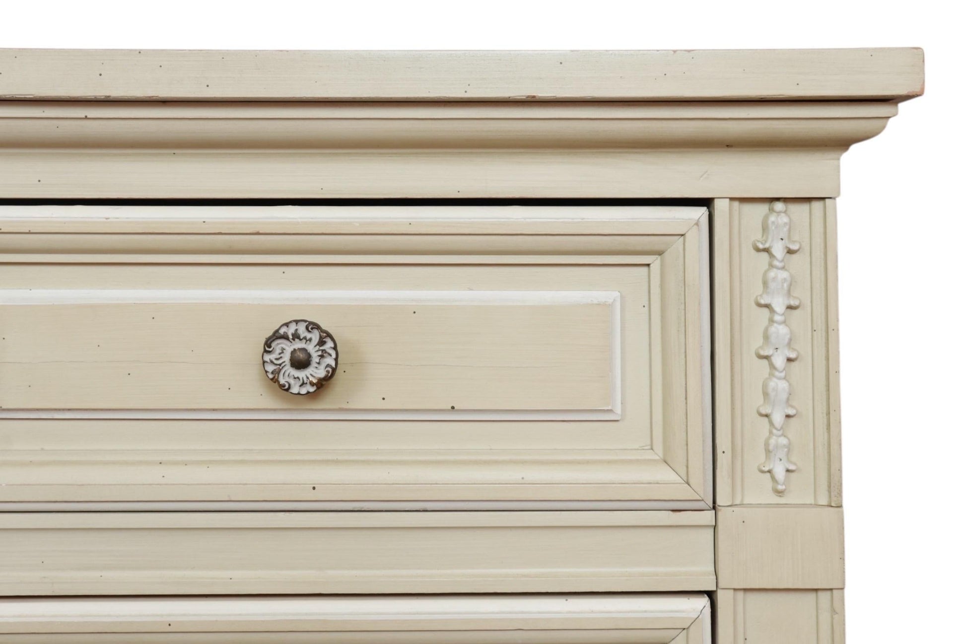 Close-up of a wooden drawer with decorative trim and a knob on a white background