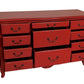 Red dresser with multiple drawers on a white background