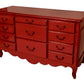 Red dresser with multiple drawers on a white background