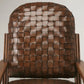 Brown woven chair with wooden frame against a white background