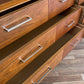 Wooden dresser with open drawers on a wooden floor