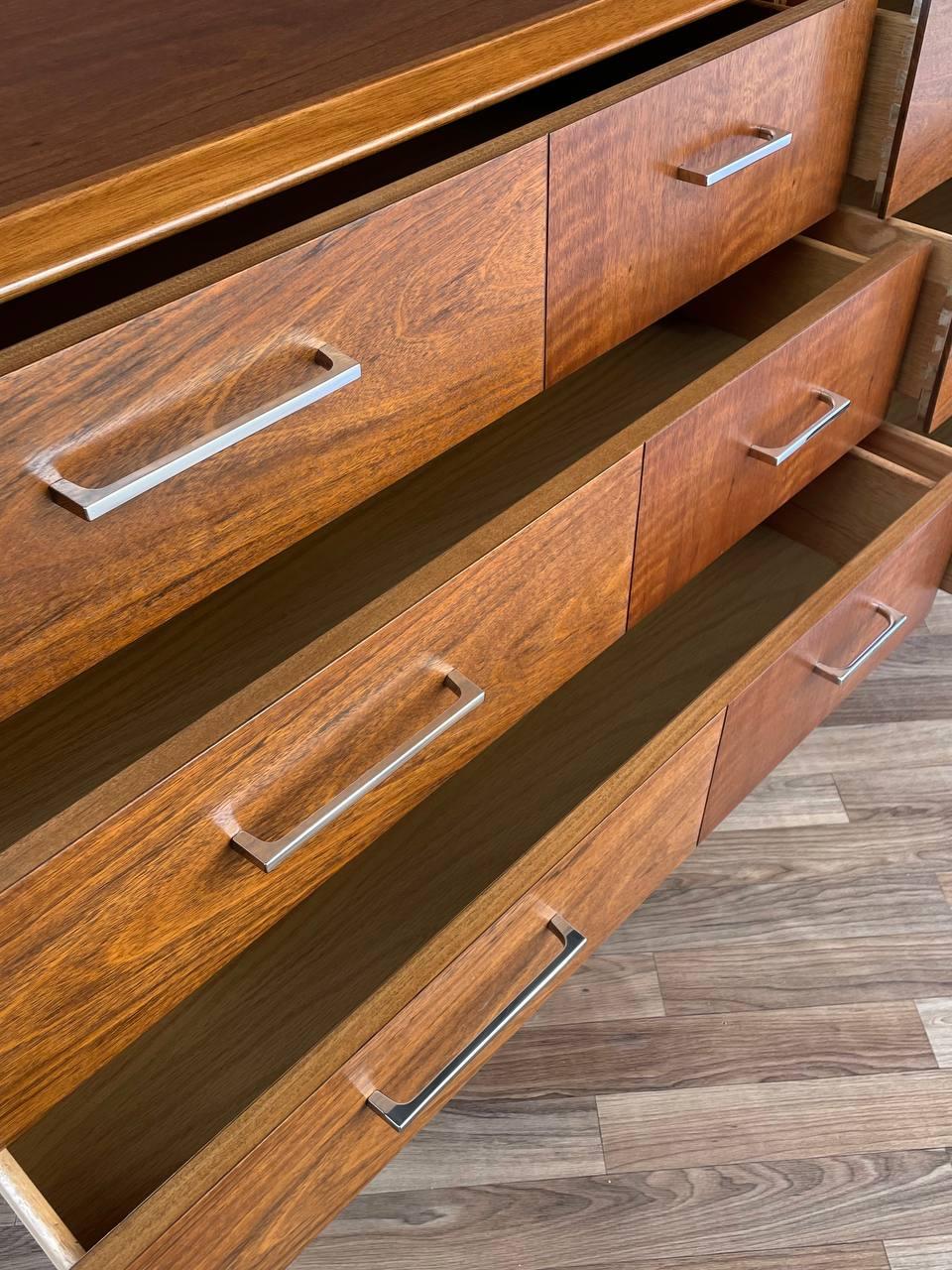 Wooden dresser with open drawers on a wooden floor