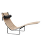 Modern lounge chair with wicker seat and black cylindrical pillow on a white background