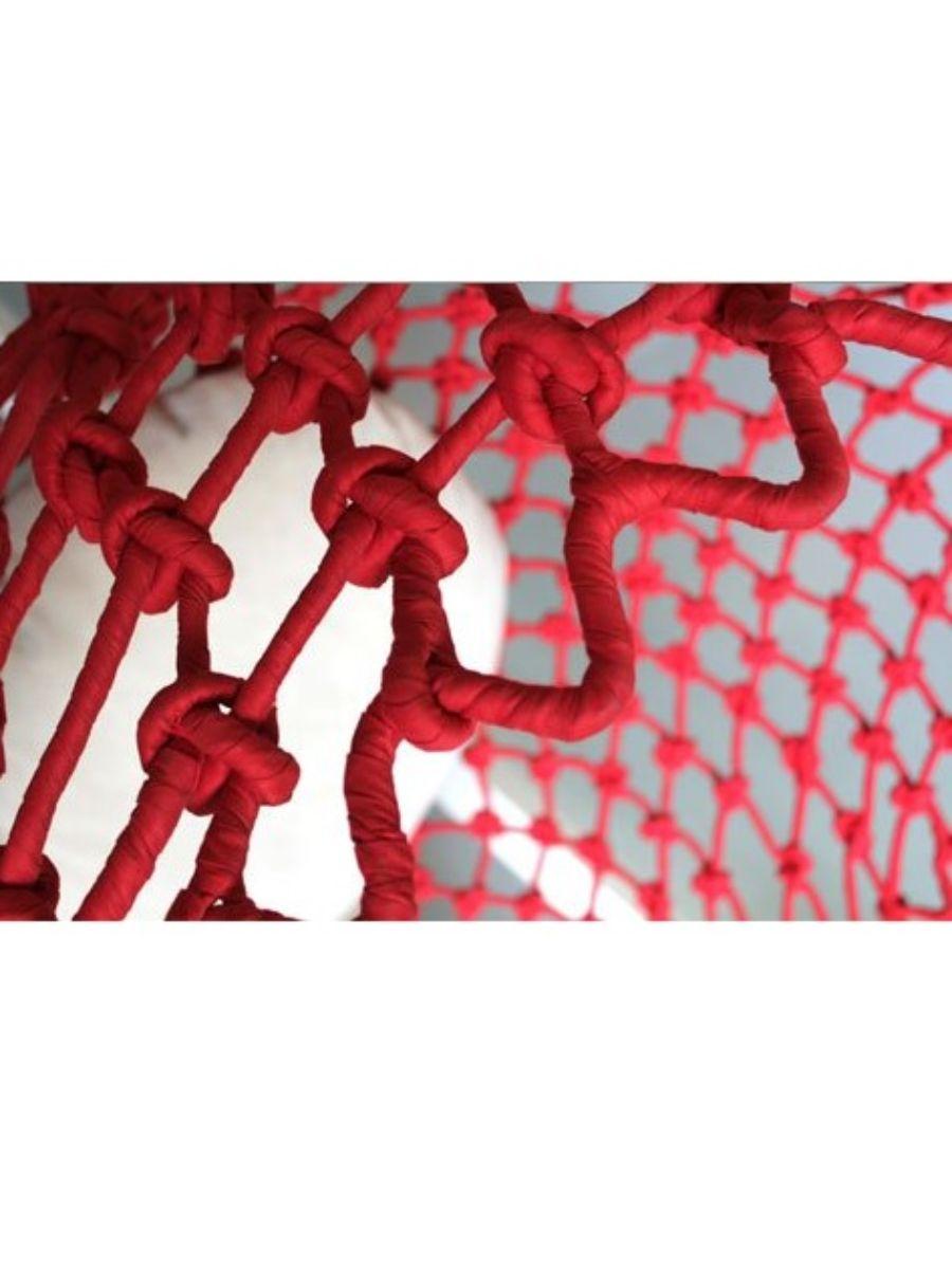 Close-up of red rope with a textured background
