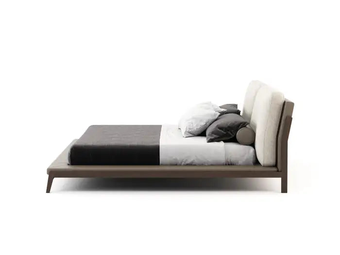 Modern bed with wooden frame and gray bedding on a white background
